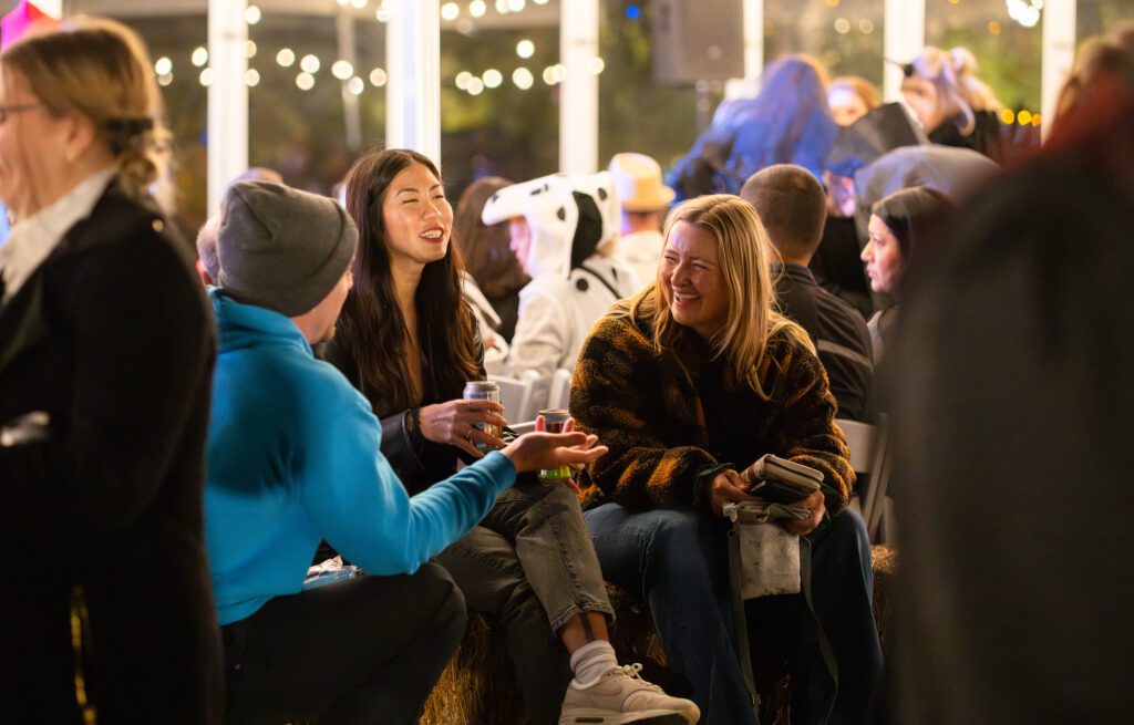 Guests under string lights at Spirits & Spirits, Four Mile Historic Park