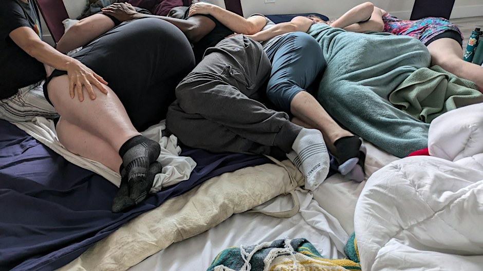 People cuddling under blankets at Community Cuddles